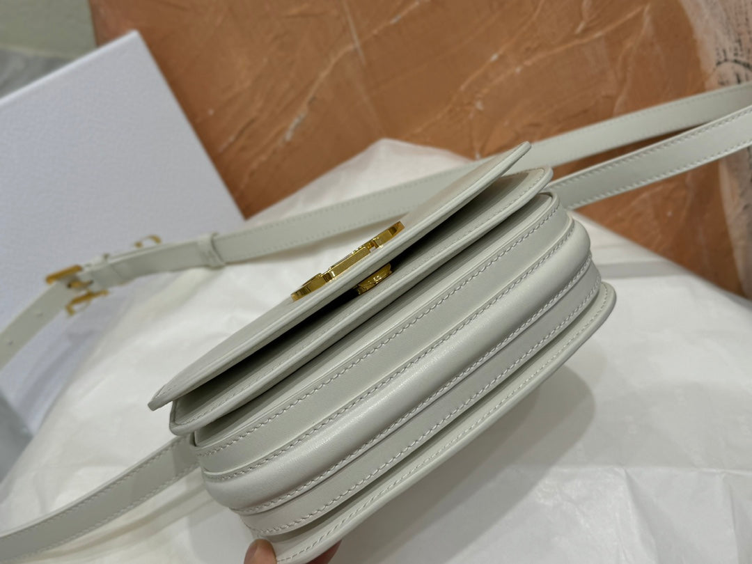 Luxury White Leather Top Handle Handbag with Gold-Tone Signature Logo and Adjustable Strap