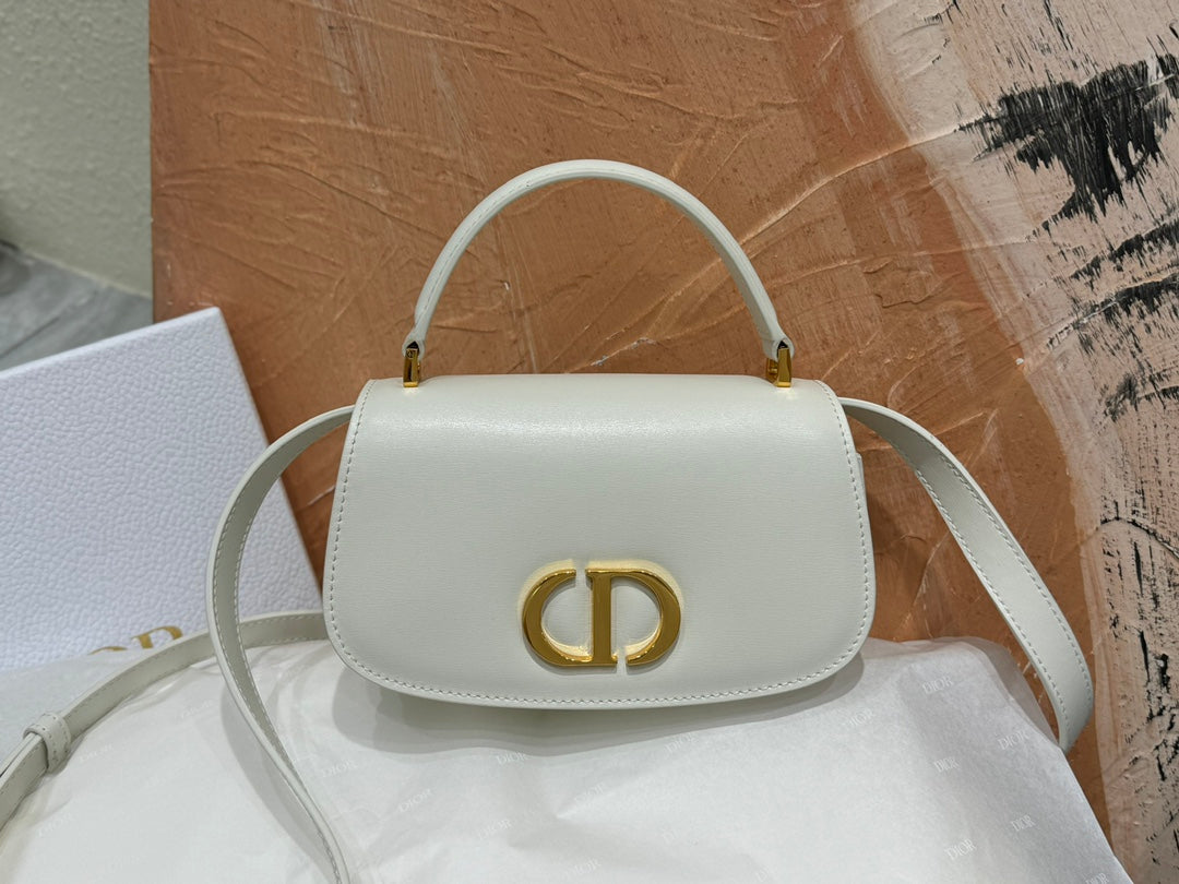 Luxury White Leather Top Handle Handbag with Gold-Tone Signature Logo and Adjustable Strap