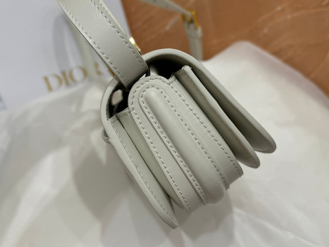 Luxury White Leather Top Handle Handbag with Gold-Tone Signature Logo and Adjustable Strap