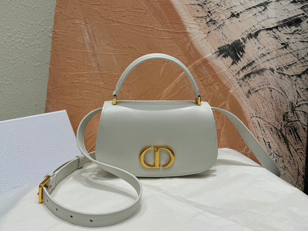 Luxury White Leather Top Handle Handbag with Gold-Tone Signature Logo and Adjustable Strap
