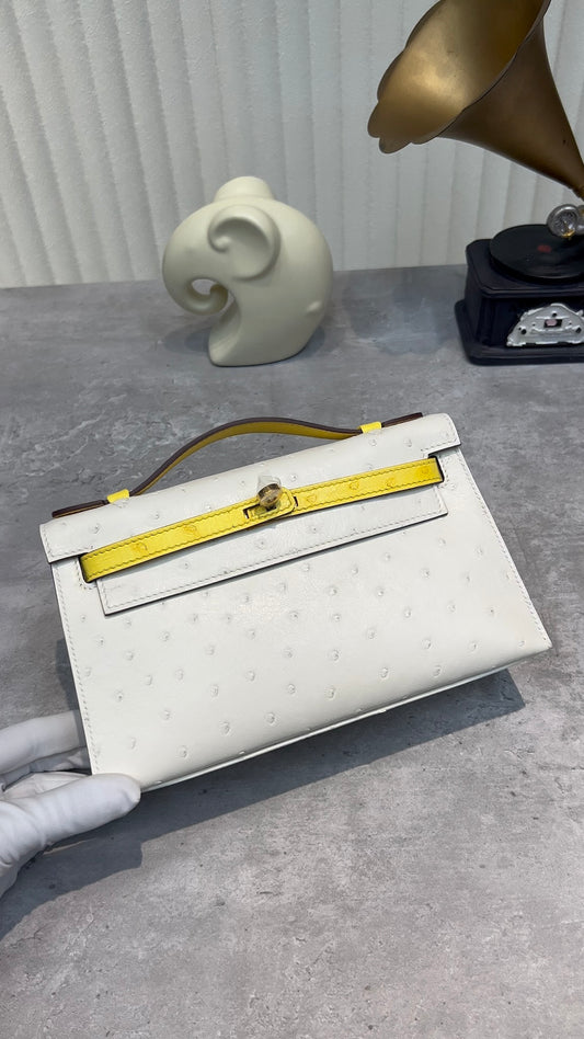 White Ostrich Embossed Top Handle Handbag with Yellow Trim and Gold Twist Lock