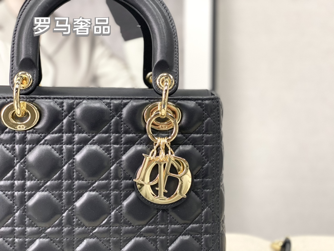 Elegant Black Quilted Top Handle Handbag with Gold-Tone Charms