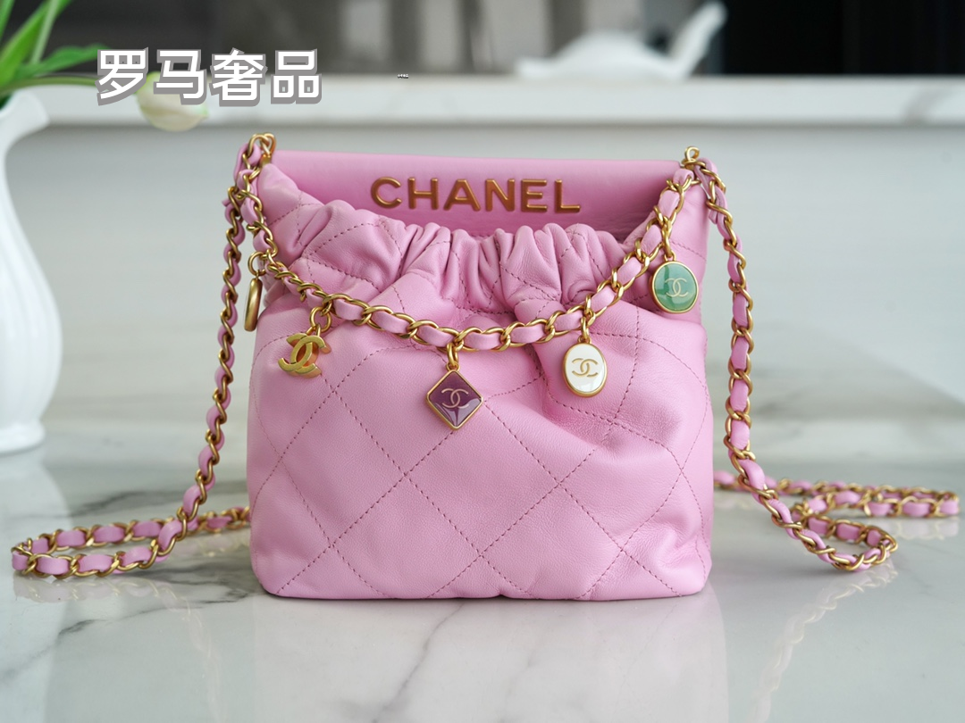 Pink Quilted Leather Bucket Bag with Gold-Tone Chain and Decorative Charms