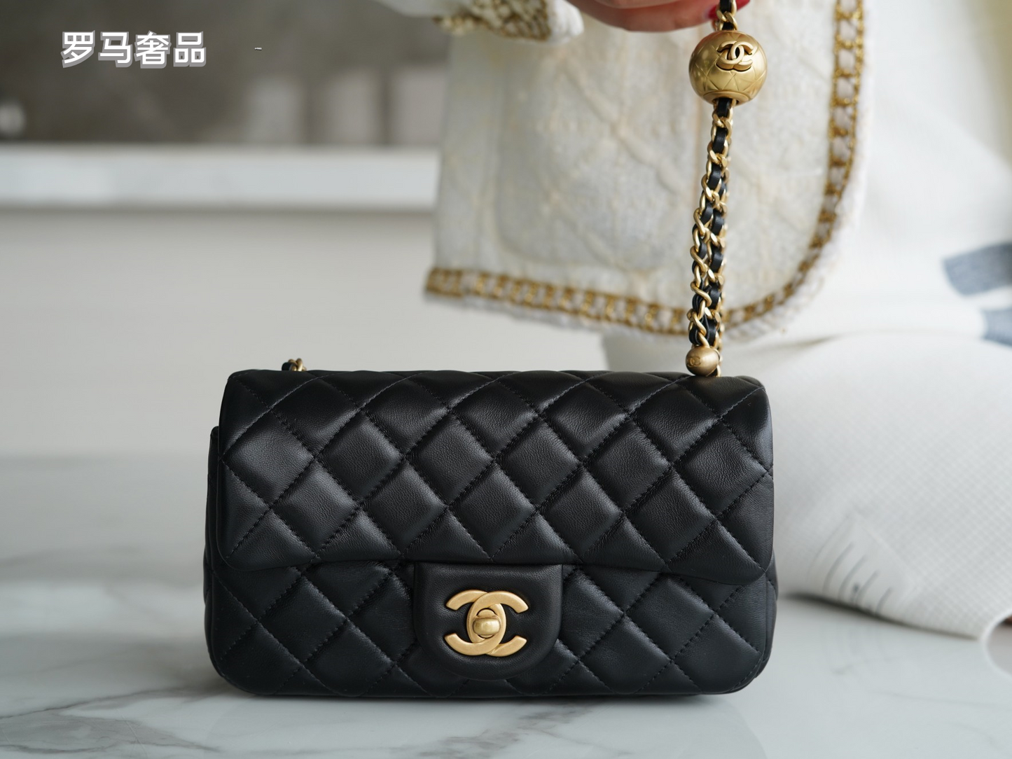 Luxury Quilted Black Leather Mini Flap Bag with Gold-Tone Chain and Ball Detail