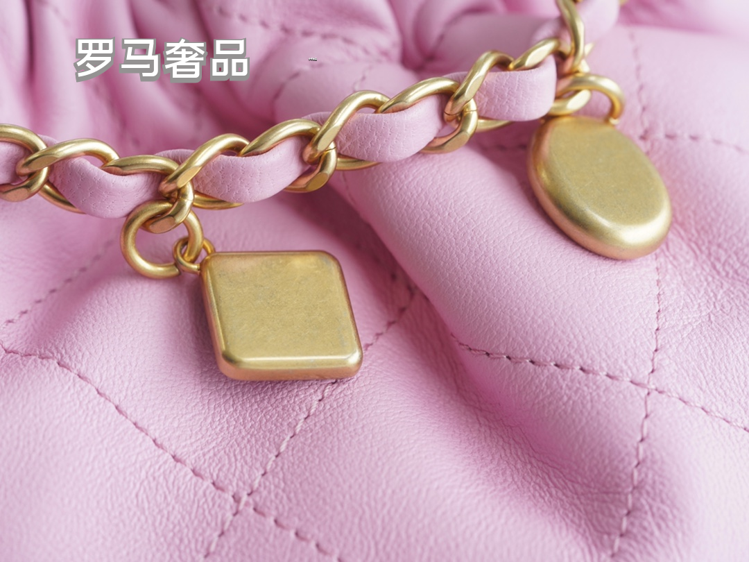 Pink Quilted Leather Bucket Bag with Gold-Tone Chain and Decorative Charms