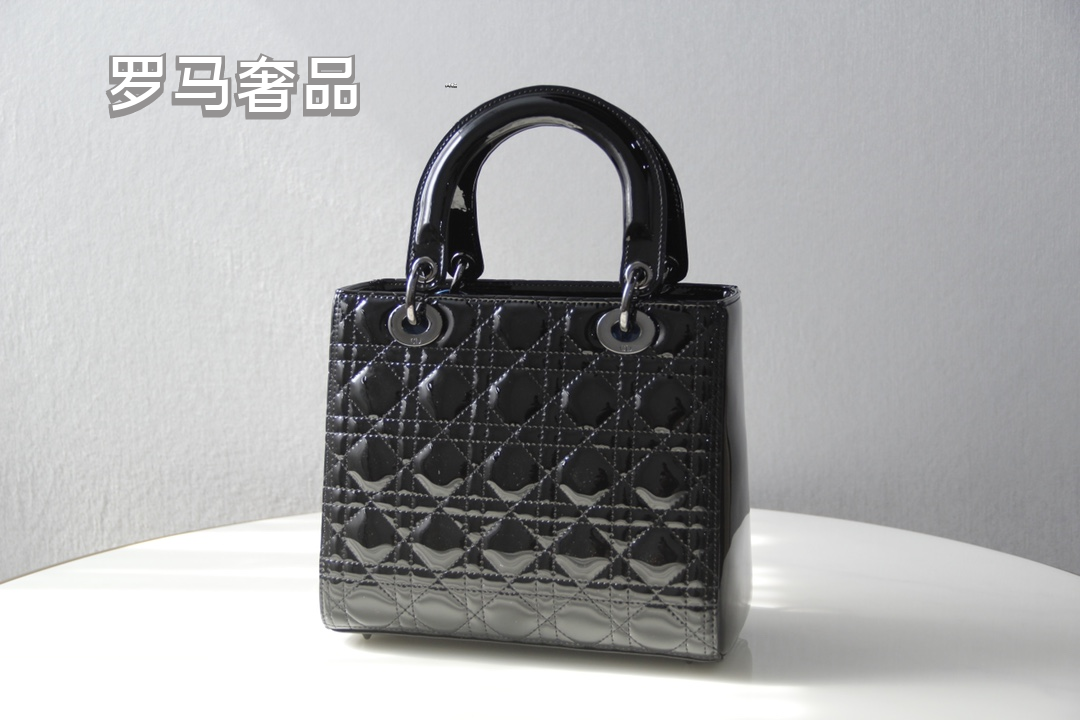 Elegant Black Quilted Top Handle Handbag with Gold-Tone Charms