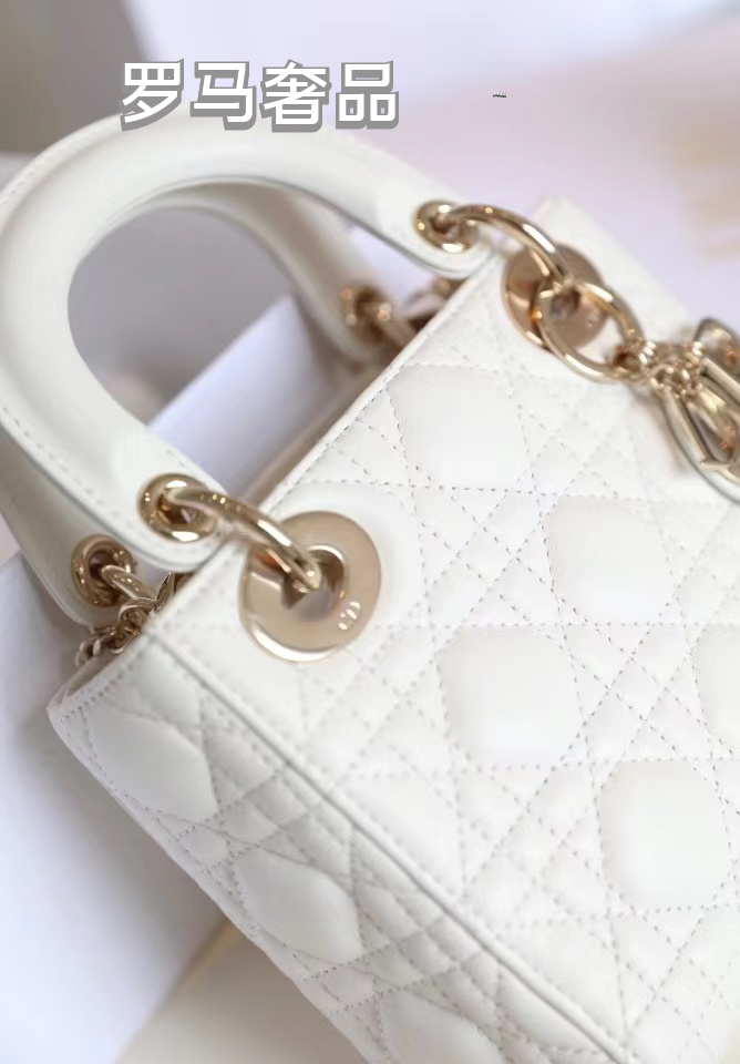 Elegant White Quilted Mini Handbag with Top Handle and Gold-Tone Charms