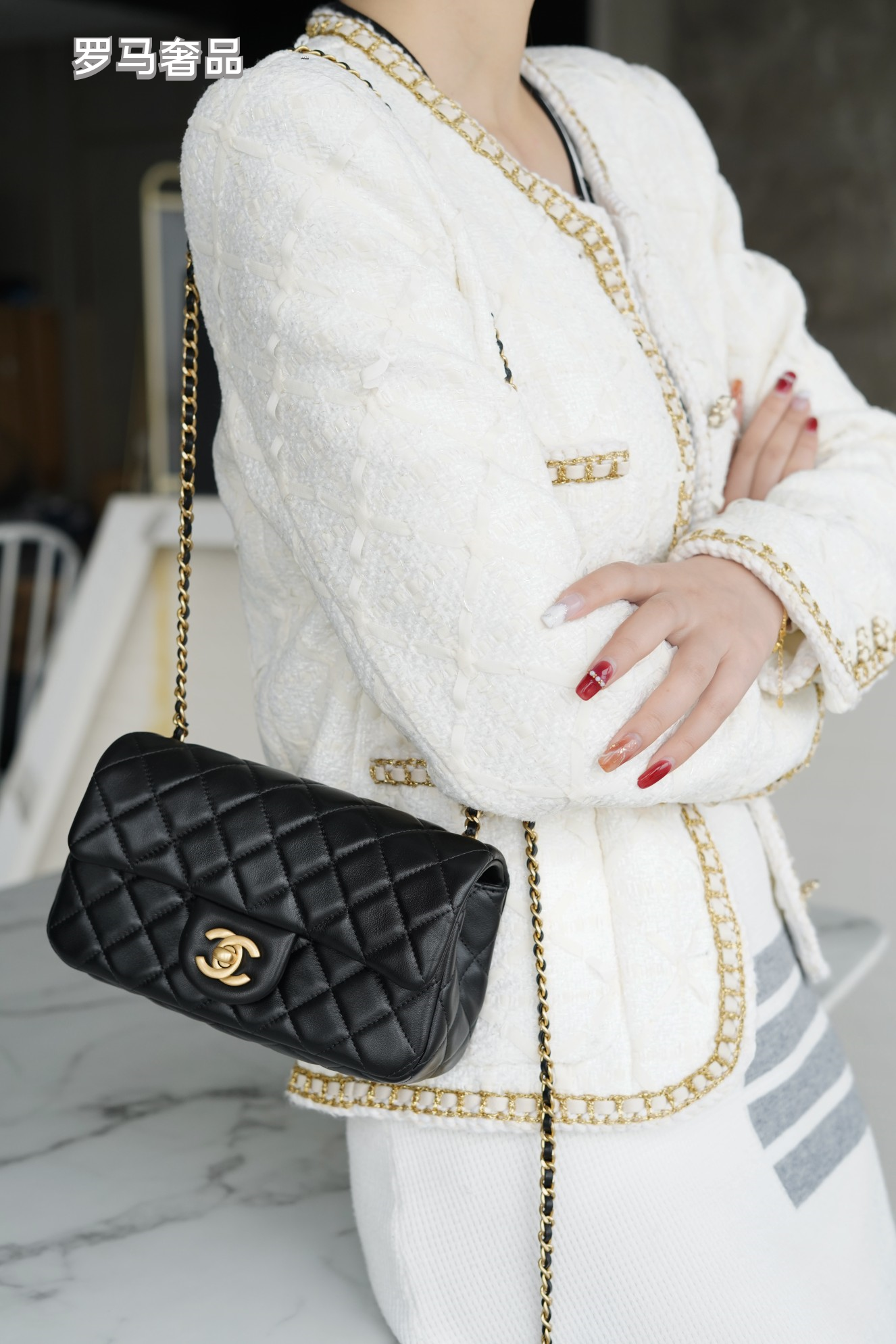Luxury Quilted Black Leather Mini Flap Bag with Gold-Tone Chain and Ball Detail