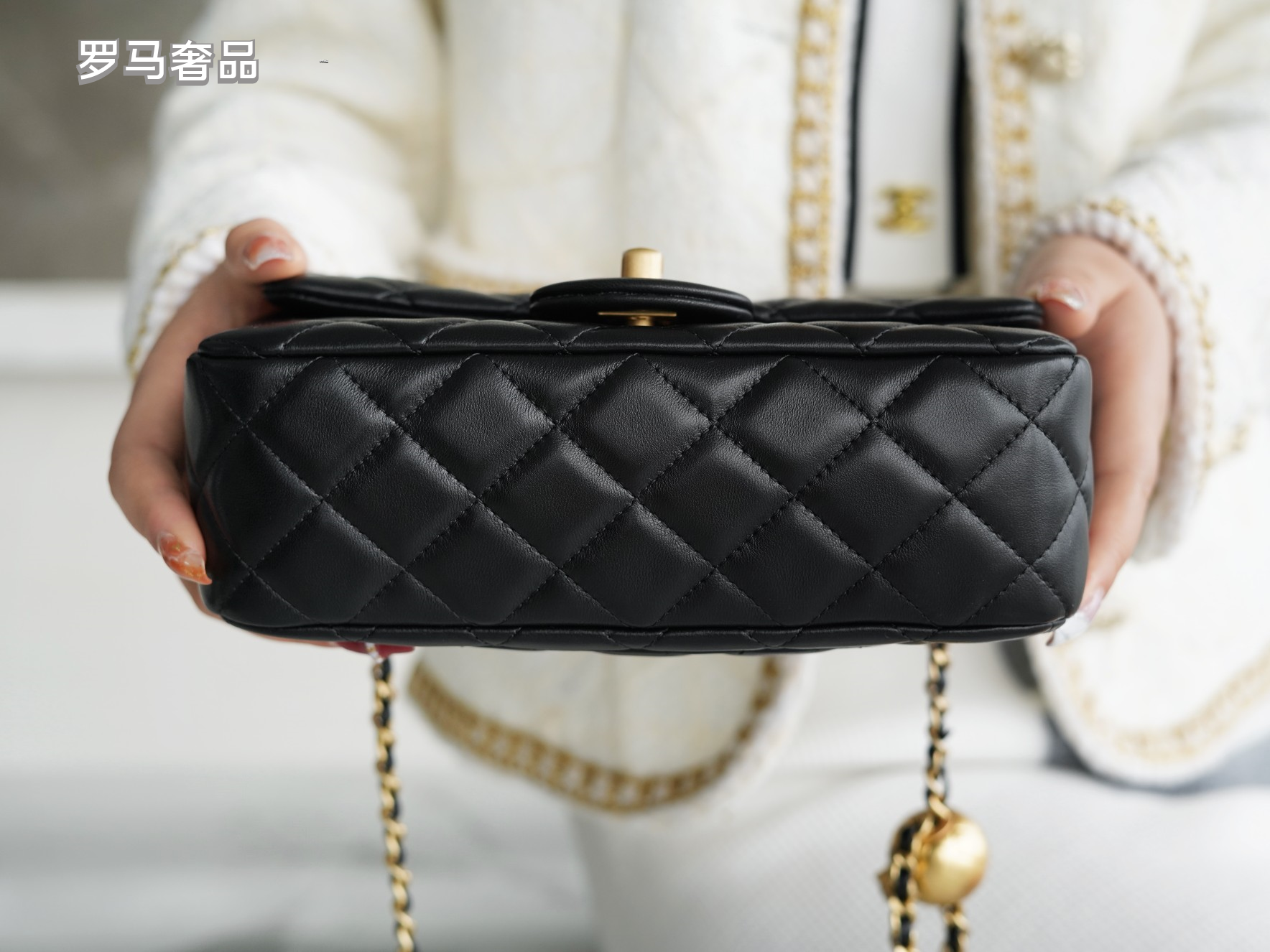 Luxury Quilted Black Leather Mini Flap Bag with Gold-Tone Chain and Ball Detail
