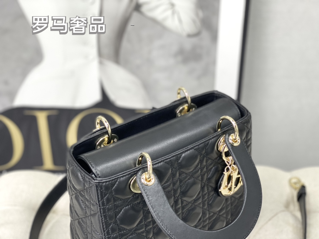 Elegant Black Quilted Top Handle Handbag with Gold-Tone Charms