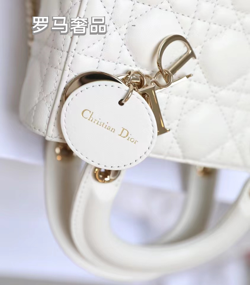 Elegant White Quilted Mini Handbag with Top Handle and Gold-Tone Charms