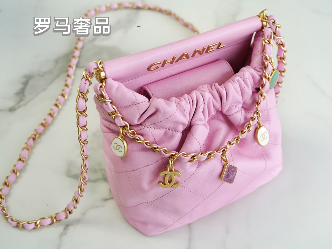 Pink Quilted Leather Bucket Bag with Gold-Tone Chain and Decorative Charms