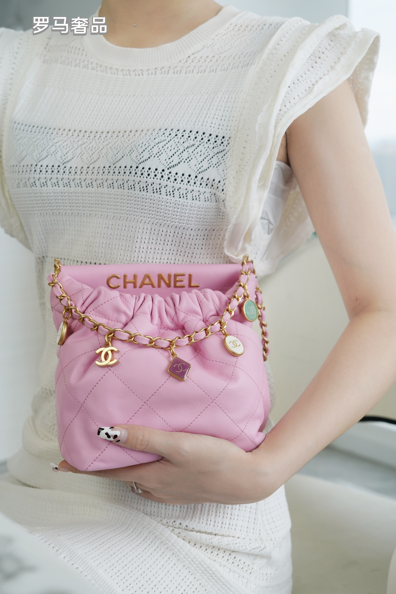 Pink Quilted Leather Bucket Bag with Gold-Tone Chain and Decorative Charms