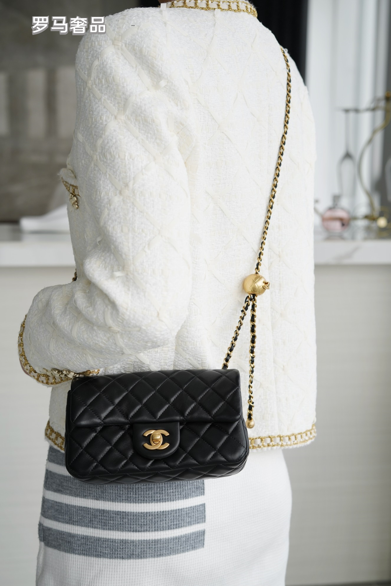Luxury Quilted Black Leather Mini Flap Bag with Gold-Tone Chain and Ball Detail