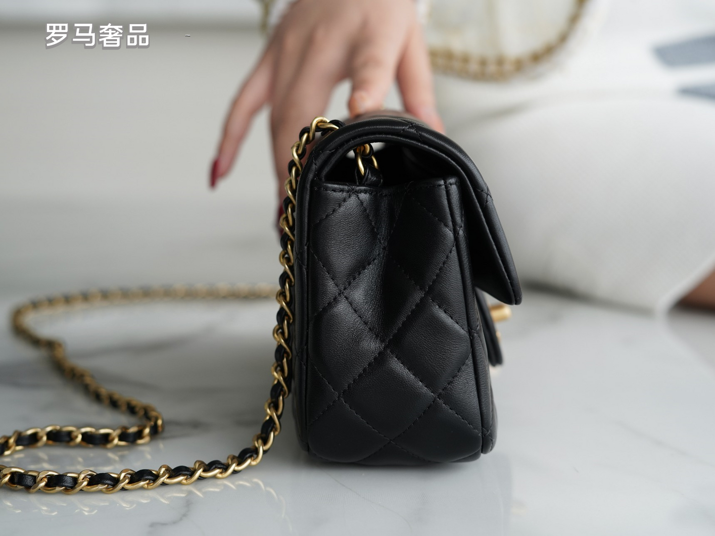 Luxury Quilted Black Leather Mini Flap Bag with Gold-Tone Chain and Ball Detail